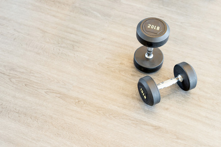 Two dumbbells on the floor in a hallの写真素材