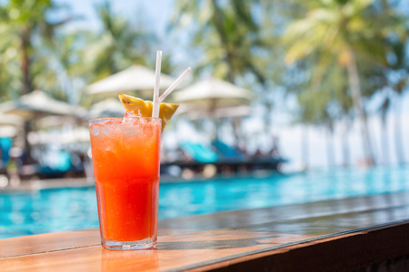 Cocktail glasses at pool, beach side.