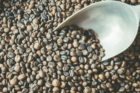 Roasted coffee beans in basket with aluminium ladle. copy space.の写真素材