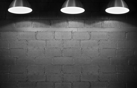Brick wall background with three spotlights. Copy space.の写真素材