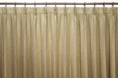 Brown curtains hang on the curtain rail.の写真素材