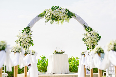 simple style wedding arch and decoration, venue, setup on tropical beach, outdoor beach wedding.の写真素材