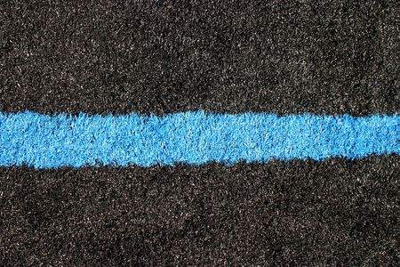 Black and blue lawn on a sports field.の写真素材