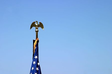 The top of a USA flag with a golden eagleの写真素材