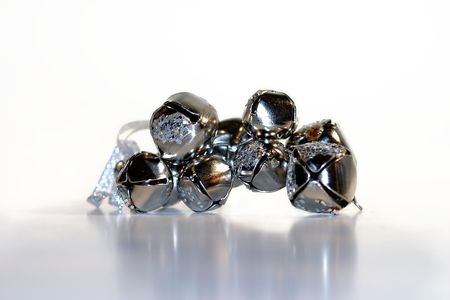 Silver shiny bells in a group on white backgroundの写真素材