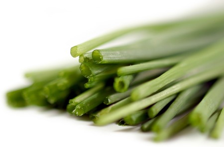 Bundle of fresh green chives on white background.