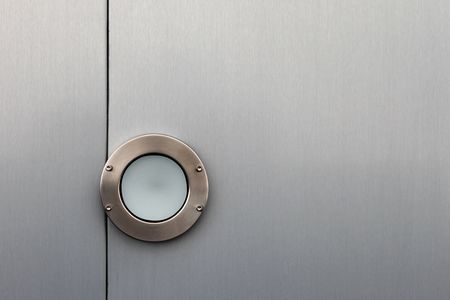 Exterior top light on a silver metal ceilingの写真素材