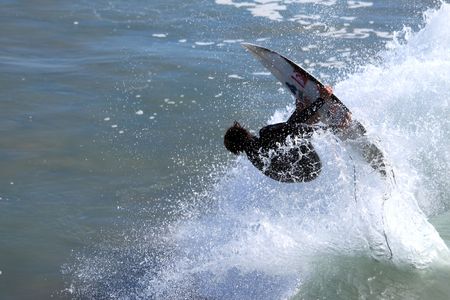 VENTURA, CA, USA - January 10, 2010 - Surfer having fun throughout a high surf event January 10,...
