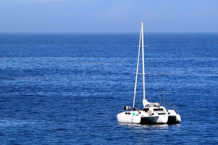 Sailboat anchoring in nice blue ocean water and sky.の写真素材