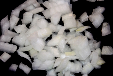Diced white regular Onion in a frying pan の写真素材