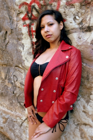 Young Hispanic woman dark hair with a read jacket の写真素材