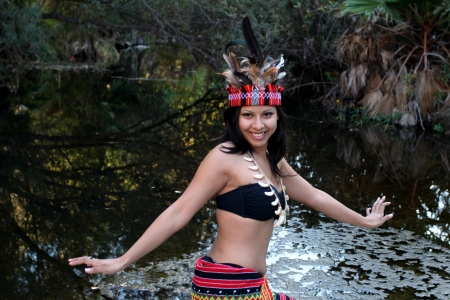 Native american woman dancing next to a creek.の写真素材