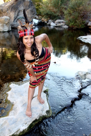 Native american woman posing next to a creek の写真素材