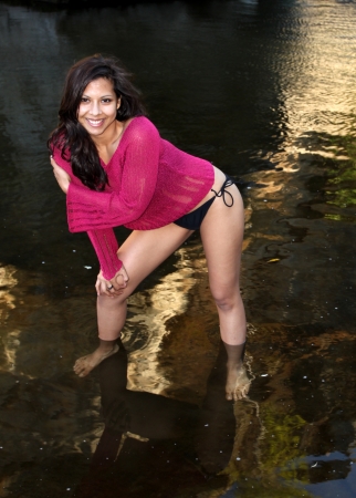 Model shot of a Hispanic beauty in front of a palm tree の写真素材