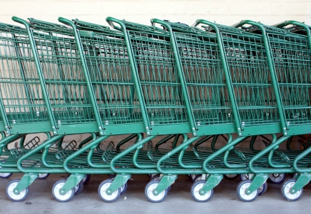 Green shopping carts together in a line up の写真素材
