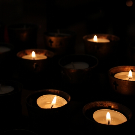 Candles in a church on black background