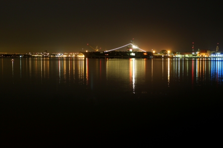 The skyline of San Diego Navy harbor at night with reflection in the water の写真素材