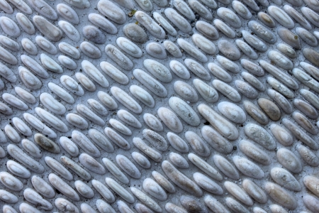 Small gray pebbles stone wall for background.の写真素材