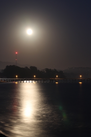 Full moon rise over the Goleta pier の写真素材