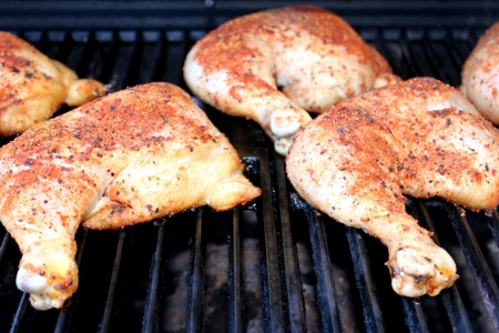 Spiced bbq chicken on the grill still raw の写真素材