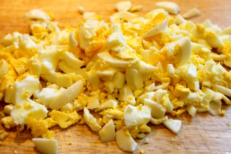 Diced eggs on a wooden board の写真素材