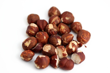 Pile of brown hazelnuts on white background.の写真素材