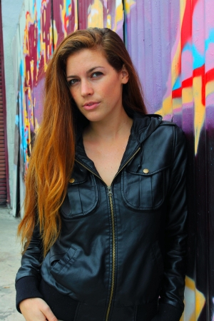 Portrait of a young womanPortrait of a young woman in front of a colorful wall.の写真素材