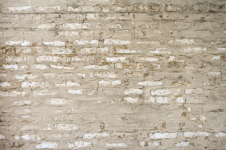 Old brick wall made with sand color stones.の写真素材