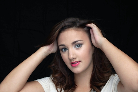 Young woman smiling in front of a black background.の写真素材