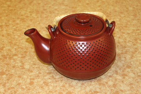 One small Japanese red teapot on a table. の写真素材