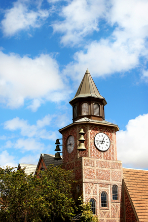 A bell tower in the city of Solvang with a cloudy sky in the background.の写真素材