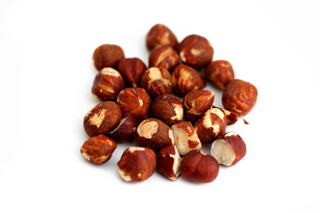 Pile of brown hazelnuts on white background.の写真素材
