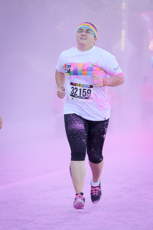 Ventura, CA - OCTOBER 18 :  Participants coming through the pink color station at The Color Run 2014 in Ventura. OCTOBER 18, 2014 in Ventura, CA.のeditorial素材