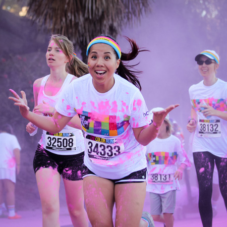 Ventura, CA - OCTOBER 18 :  Participants coming through the pink color station at The Color Run 2014 in Ventura. OCTOBER 18, 2014 in Ventura, CA.のeditorial素材