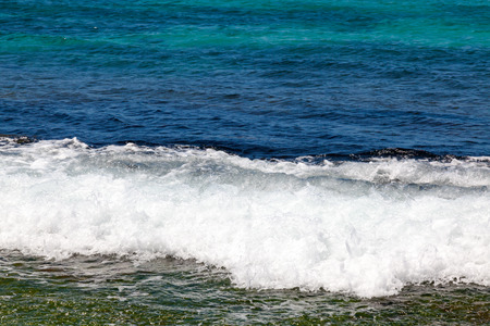 Ocean waves breaking on shore of tropical island in the Pacific.の写真素材