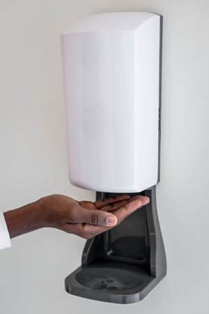 Alcohol gel dispenser on a wall in the new normalの写真素材