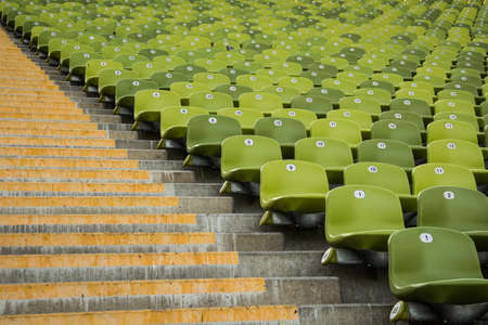 Rows of green seats and stairs in stadiumの写真素材