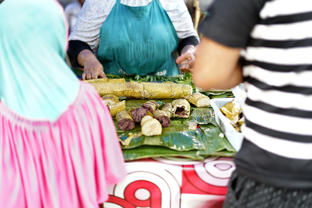 People buying Sticky Rice desserts in street food market during ramadan fasting month at Banda Aceh City, Aceh Province, Indonesia.の写真素材
