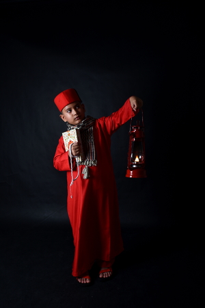 Muslim boy holding The Holy Koran and lanternの写真素材