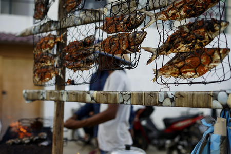 Food vendor cooks and sells Barbecue Grill fish at the street market in Banda Aceh Cityの写真素材