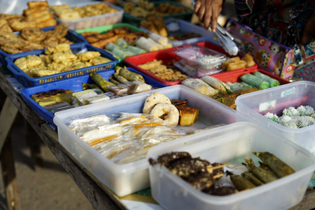 Vendor selling variety of local cakes and dessert during fasting month at Street market food in Banda Aceh, Indonesiaの写真素材