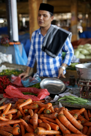 Banda Aceh, Aceh / Indonesia - May 25 2018  : Vegetable Vendor selling Fresh Organic carrot in farmer's market in Banda Aceh, Indonesiaのeditorial素材