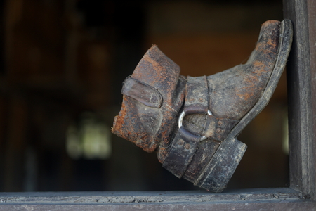 Old dusty vintage boot at abandoned buildingの写真素材
