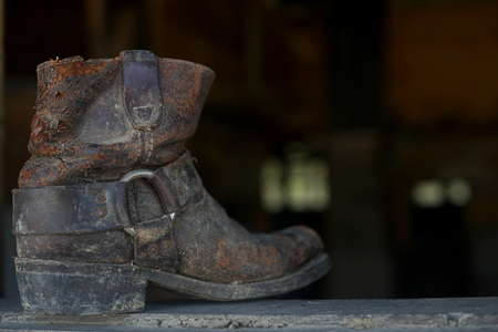 Old dusty vintage boot at abandoned buildingの写真素材