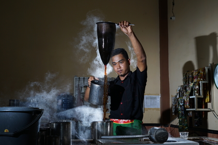 Traditional process of Aceh coffee making by Barista at Local Coffee Shop