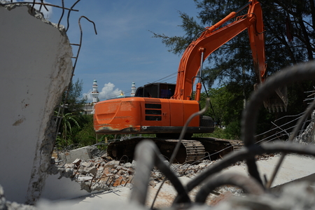 Hydraulic crusher excavator backoe machinery working on site demolition