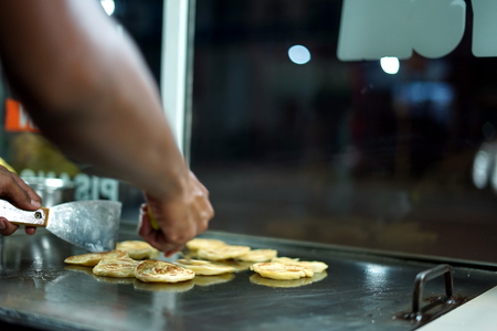 Vendor Frying Roti canai/Indian flat bread at street food marketの写真素材