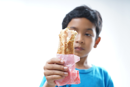 Young Boy eating kebab or shawarmaの写真素材