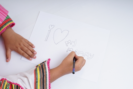 Teenage girl writing Mother's Day messageの写真素材