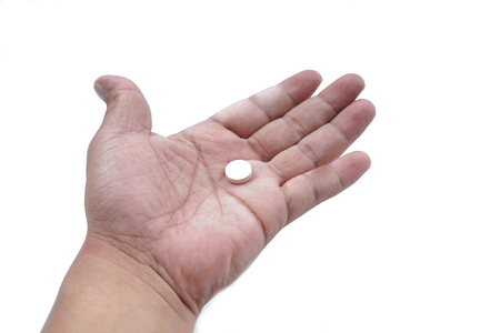 Hands Holding Pills medicine on white backgroundの写真素材